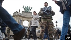 A French legionnaire patrols outside the Grand Palais museum near the Champs Elysees avenue in Paris, part of the reinforced security guarding gathering places around France, Dec. 30, 2015.