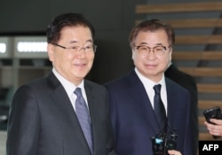 South Korea's national security advisor Chung Eui-yong (L) and spy chief Suh Hoon (R) arrive at Incheon airport, west of Seoul, on March 8, 2018 to leave for Washington.