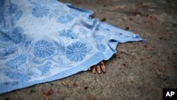 FILE - A body of a civilian killed in shelling is covered by a blanket in Donetsk, eastern Ukraine, Jan. 30, 2015. 