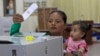 FILE - A Cambodian woman votes in the senate election at Takhmau polling station in Kandal province, southeast of Phnom Penh, Cambodia, Feb. 25, 2018. The general election is in July.