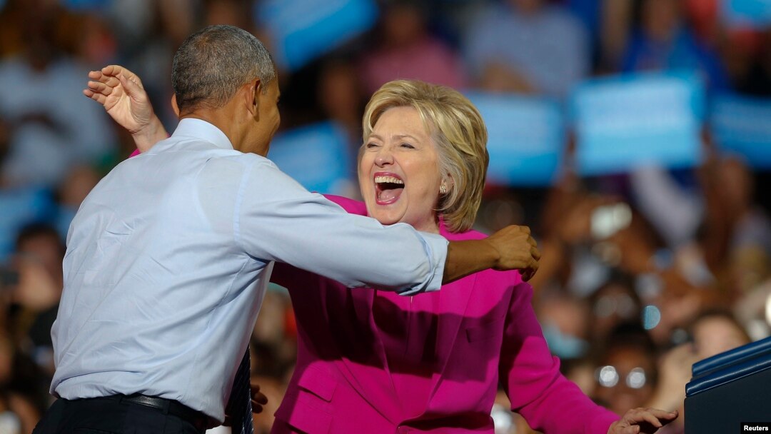 FILE - President Barack Obama and Democratic presidential candidate Hillary Clinton embrace during a campaign rally in Charlotte, North Carolina, July 5, 2016.