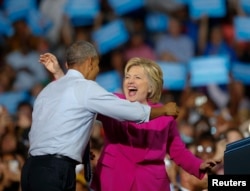 President Barack Obama and Democratic presidential candidate Hillary Clinton embrace during a campaign rally, July 5, 2016, in Charlotte, N.C..