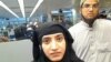 This July 27, 2014 photo provided by U.S. Customs and Border Protection shows Tashfeen Malik, left, and Syed Farook, as they passed through O'Hare International Airport in Chicago.