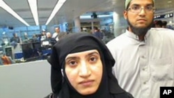 This July 27, 2014 photo provided by U.S. Customs and Border Protection shows Tashfeen Malik, left, and Syed Farook, as they passed through O'Hare International Airport in Chicago.