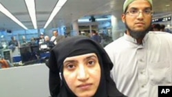 A July 27, 2014, photo shows San Bernardino shooters Tashfeen Malik (L) and Syed Farook, as they passed through passport control O'Hare International Airport in Chicago. The FBI wants Apple to hack into Farook's iPhone.