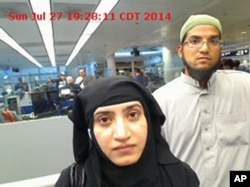 FILE - This July 27, 2014 photo provided by U.S. Customs and Border Protection shows Tashfeen Malik, left, and Syed Farook, as they passed through O'Hare International Airport in Chicago.