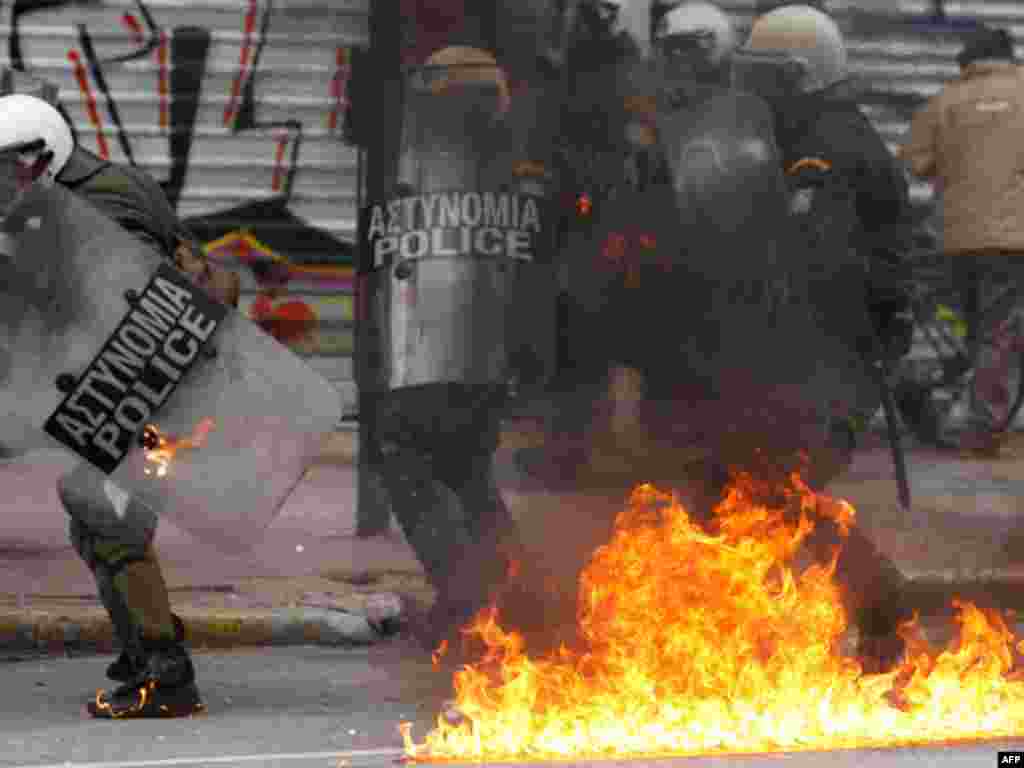Riot police try to avoid a gasoline bomb during clashes in Athens, February 10, 2012. (AP)