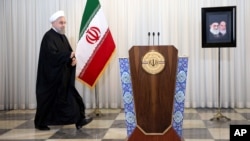 FILE - Iran's president, Hassan Rouhani, arrives for an address to the nation, at his office in Tehran, Iran, Dec. 16, 2015.