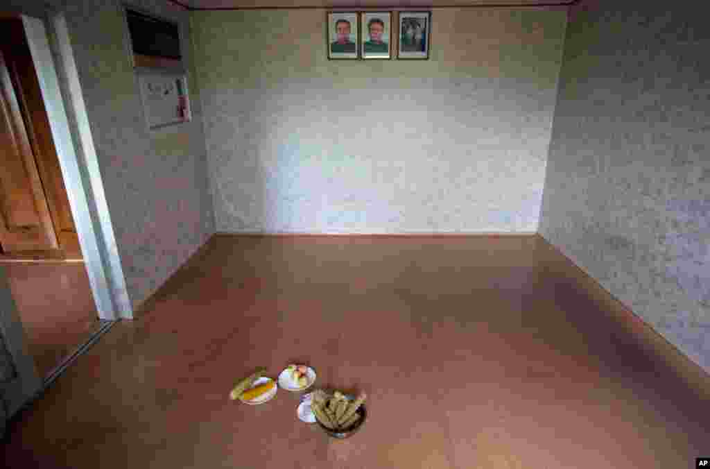Bowls of boiled corn and peaches are served as a snack inside a farmhouse at Tongbong cooperative farm in Hamju County, Hamgyong Province, North Korea.
