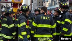 Fire Department of New York (FDNY) firefighters stand near Port Authority Bus Terminal after reports of an explosion in Manhattan, New York, U.S., Dec. 11, 2017. 