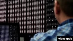 一位男子注释着电脑屏幕上的数据。
