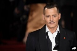 Actor Johnny Depp poses for photographers at the world premiere of the film "Murder on the Orient Express," in London, Nov. 2, 2017.