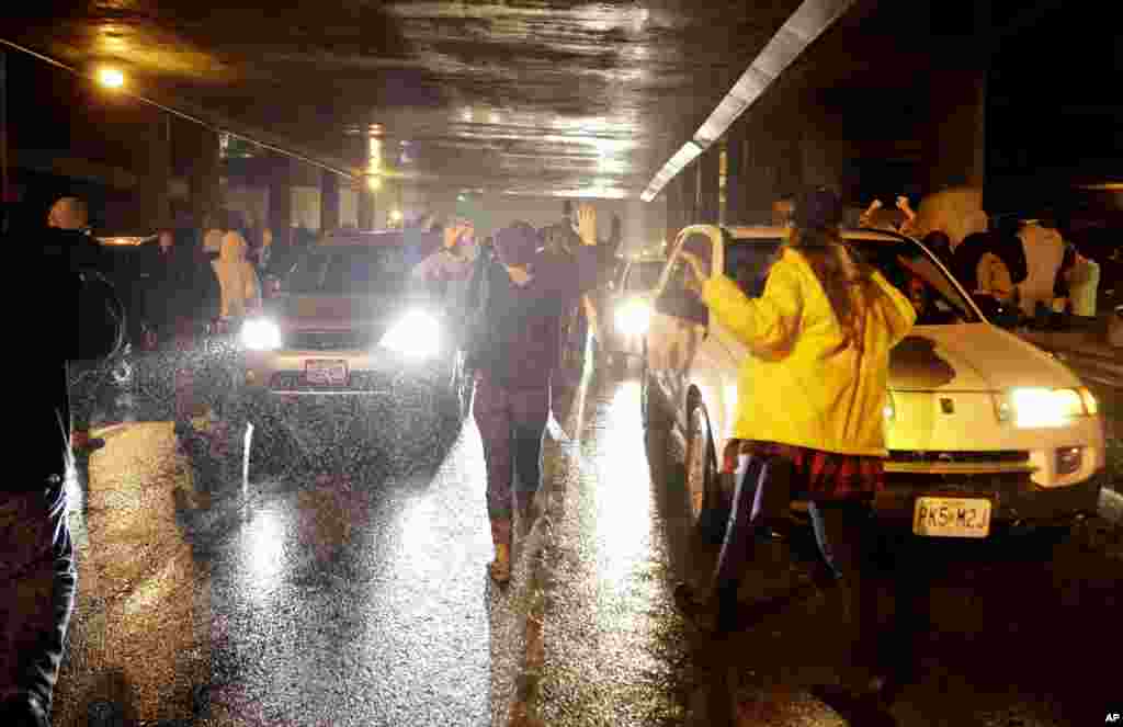 Protesters block traffic as they march in the streets, in St. Louis, Missouri. Ferguson and the St. Louis region are on edge in anticipation of the announcement by a grand jury whether to criminally charge officer Darren Wilson in the shooting death of Michael Brown, Nov. 23, 2014.