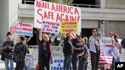 Demonstrators who support President Trump's order barring entry to the U.S. by travelers from seven Muslim-majority countries hold signs outside the Los Angeles International Airport, Feb. 4, 2017.