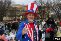 A Trump supporter dressed as "Uncle Sam" in head-to-toe red, white and blue awaits Donald Trump's inauguration as the 45th president of the United States, Jan. 20, 2017. (Photo: B. Allen / VOA)