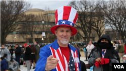 A Trump supporter dressed as "Uncle Sam" in head-to-toe red, white and blue awaits Donald Trump's inauguration as the 45th president of the United States, Jan. 20, 2017. (Photo: B. Allen / VOA)