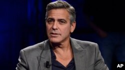 FILE - George Clooney is interviewed on the Italian State RAI TV program "Che Tempo che Fa," in Milan, Italy, Feb. 9, 2014. 