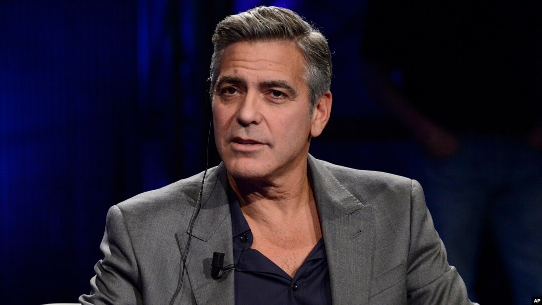 FILE - George Clooney is interviewed on Italy's RAI TV in Milan, Feb. 9, 2014. 