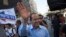 Jerusalem Mayor Nir Barkat waves as he campaigns for mayoral elections in Jerusalem, Oct. 22, 2013. 