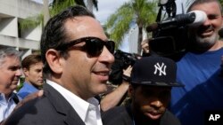 Anthony Bosch, foreground, former owner of the Biogenesis of America clinic, leaves the federal courthouse in Miami after paying bond, Aug. 5, 2014. 