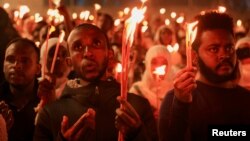 FILE - Ethiopian Orthodox faithful hold candles during the Meskel festival celebration to commemorate the discovery of the True Cross on which Jesus Christ was crucified, in Addis Ababa, Ethiopia, September 27, 2023.