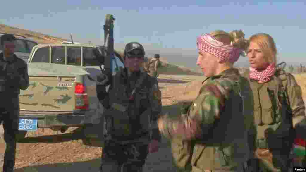 Peshmerga fighters are seen in Khazer, west of Erbil, Iraq in this still frame taken from video, Oct. 17, 2016.