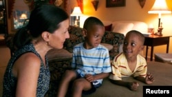 American Theresa Alden talks with her adopted foreign-born sons, Gavin (C), 6, and Graem, 4, at their home in Lancaster, Pennsylvania (file photo).