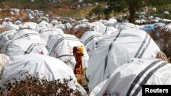 FILE - An Ethiopian girl carries water at the Somare refugee camp on the Ethiopia-Kenya border near the town of Moyale, Kenya, March 27, 2018.