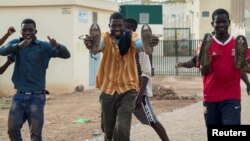 FILE - African migrants react as they arrive at the short-stay immigrant center after crossing the border from Morocco to Spain’s North African enclave of Melilla, Spain, June 26, 2016.