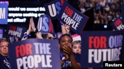 Attendees react during Day 2 of the Democratic National Convention in Chicago, Illinois, Aug. 20, 2024. 