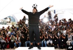 FILE - Former Argentine soccer player Diego Maradona poses during the photo call for the documentary "Maradona" during the 61st International film festival in Cannes, southern France, May 20, 2008.