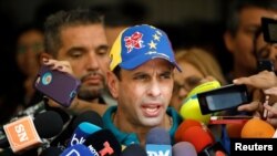 FILE - Venezuela's opposition leader Henrique Capriles speaks to the media in Caracas, Oct. 15, 2017. 