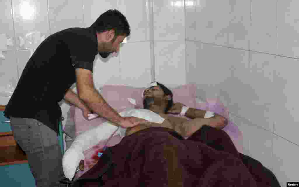 A man rests in a hospital bed after being wounded during a suicide bombing attack in Baquba, about 50 kilometers northeast of Baghdad, July 2, 2013.
