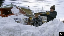 Residents clear snow in Lonquimay, Araucania Region, located 730 kilometers south of Santiago, Chile, July 20, 2011