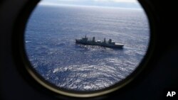 FILE - HMAS Success, as seen from a Royal New Zealand Air Force P3 Orion, patrols the Indian Ocean searching for the missing Malaysia Airlines Flight 370 off the coast of Western Australia, March 31, 2104.. 