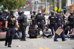 Louisville police detain a group who marched, Sept. 23, 2020, in Louisville, Ky. A grand jury has indicted one officer on criminal charges six months after Breonna Taylor was fatally shot by police in Kentucky.