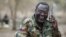 FILE - South Sudan's rebel leader Riek Machar talks on the phone in his field office in a rebel-controlled territory in Jonglei State, South Sudan, Feb. 1, 2014. 