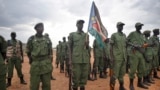 South Sudanese rebel soldiers stand to attention at a military camp in the capital Juba, South Sudan, Thursday, April 7, 2016. (AP Photo/Jason Patinkin)