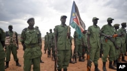 FILE- South Sudanese former rebel soldiers stand to attention at a military camp in the capital Juba, South Sudan, Thursday, April 7, 2016. (AP Photo/Jason Patinkin)