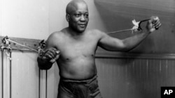 FILE - In this 1932 file photo, boxer Jack Johnson, the first black world heavyweight champion, poses in New York City. 