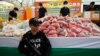 FILE - A policeman guards bags of methamphetamine pills during the 42nd Destruction of Confiscated Narcotics ceremony in Ayutthaya province, nearly 80 km (50 miles) north of Bangkok.