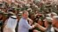 President George H.W. Bush is greeted by Saudi troops and others as he arrives in Dhahran, Saudi Arabia, for a Thanksgiving visit, Nov. 22, 1990. Bush died at the age of 94 on Friday, Nov. 30, 2018, about eight months after the death of his wife, Barbara Bush.