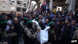 Palestinians and Hamas fighters attend a funeral procession for 40 militants and civilians killed during the war with Israel, at the Shati camp for Palestinian refugees north of Gaza City on Feb. 28, 2025, amid the current ceasefire deal in in the war between Israel and Hamas.