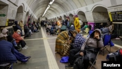 People take shelter inside a metro station during a Russian missile strike, amid Russia's attacks on Ukraine, in Kyiv, Ukraine, April 11, 2024.