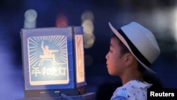 A boy holds a paper lantern in remembrance of victims of the 1945 atomic bombing on a day commemorating the 74th anniversary of the bombing in Nagasaki, western Japan. (Kyodo)