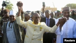 FILE - Burkina Faso Prime Minister Apollinaire Joachim Kyelem de Tambela, center, is pictured at a rally in Niamey, Niger, Dec. 29, 2023. Tambela has been fired, according to a government decree issued Dec. 6, 2024.