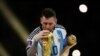 FILE: Argentina's Lionel Messi kisses the World Cup trophy after receiving the Golden Ball award as he celebrates after winning the World Cup. Taken December 18, 2022