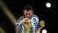 FILE: Argentina's Lionel Messi kisses the World Cup trophy after receiving the Golden Ball award as he celebrates after winning the World Cup. Taken December 18, 2022