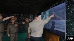 This photo reportedly taken on Sept. 18, 2024, and released from North Korea's official Korean Central News Agency on Sept. 19, 2024, shows North Korean leader Kim Jong Un inspecting the test firing of a new tactical ballistic missile, at an undisclosed location in North Korea.