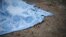 FILE - A body of a civilian killed in shelling is covered by a blanket in Donetsk, eastern Ukraine, Jan. 30, 2015. 